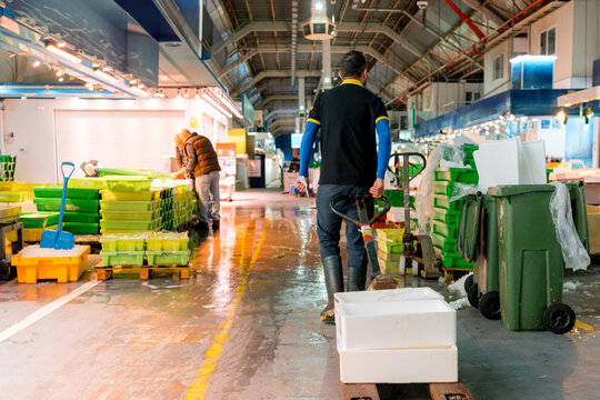 Fishmonger at work in a busy wholesale fish market