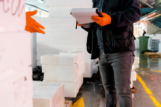 Fish wholesale market worker inspect seafood delivery inventory