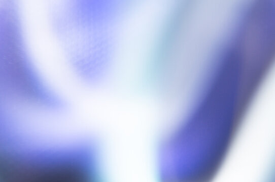 Holographic iridescent background with vibrant purple and blue gradients. Abstract ethereal texture with soft pastel light leaks. 