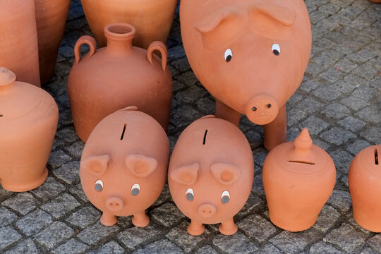 Terracotta piggy banks and clay pottery at a market stall