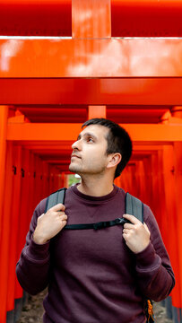 Tourist at Osaka Tenmangu Shrine torii gate