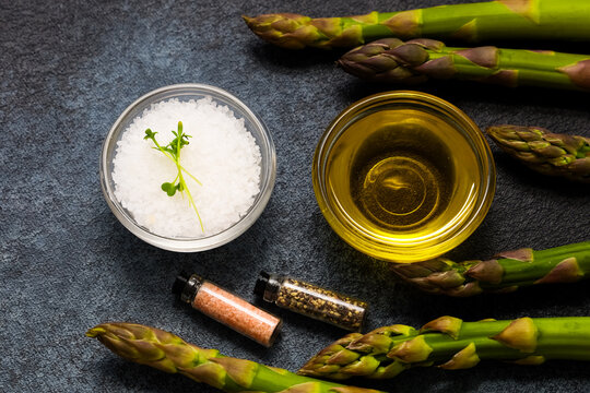 Fresh asparagus with salt oil and spices ready for cooking