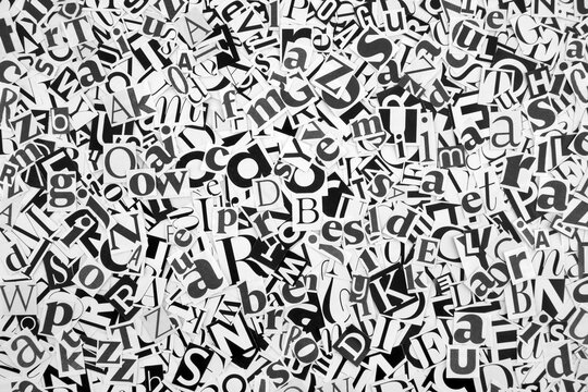 Pile of many black and white letters from newspapers and magazines. Typography background composition