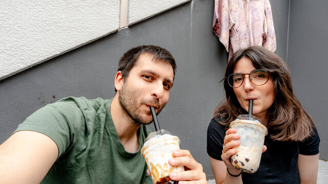 Couple enjoying bubble tea on Takeshita Street