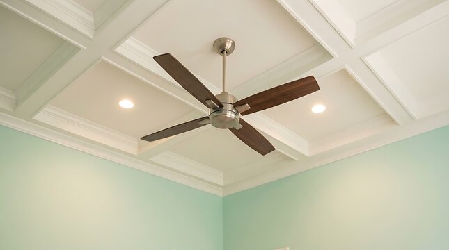 Modern ceiling fan installed in a cozy bedroom. Contemporary indoor ceiling fixture with wooden blades.
