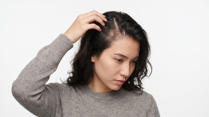 Fototapeta premium Worried young woman touching her hair showing visible thinning and hair loss