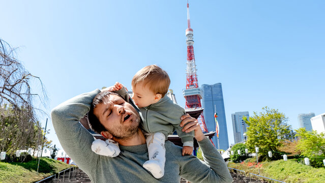 Father and child at Zojo-ji Temple with Tokyo Tower