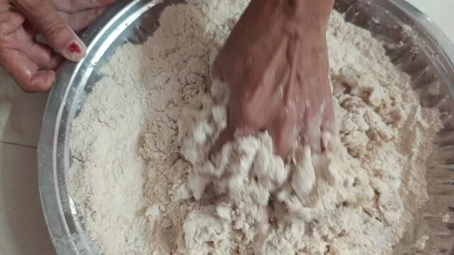 Close-up of woman hands sifting wheat flour and kneading dough in traditional dish