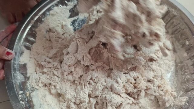 Close-up of woman hands sifting wheat flour and kneading dough in traditional dish