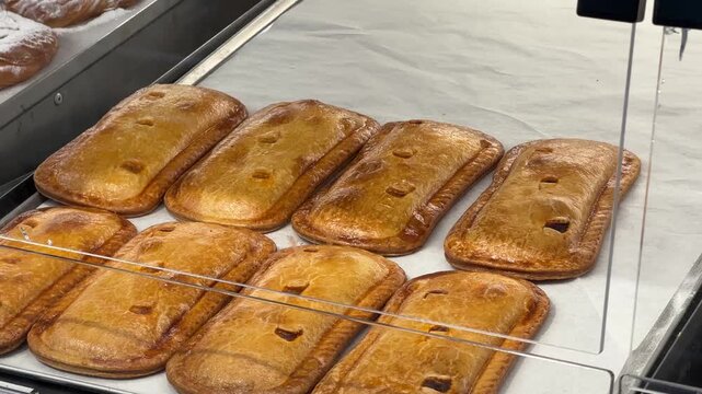 Powdered sugar pastries in a bakery display case