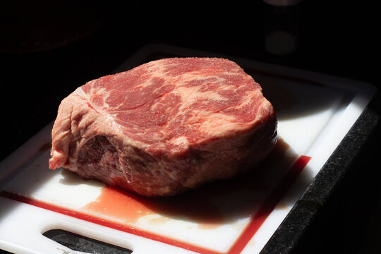 Raw beef hump cut (cupim) on cutting board with natural light