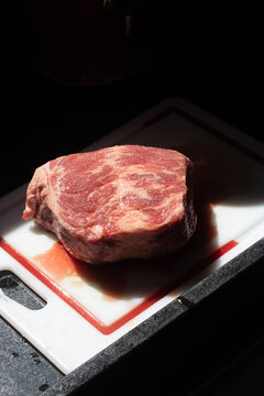 Fresh raw cupim beef cut close up on white cutting board
