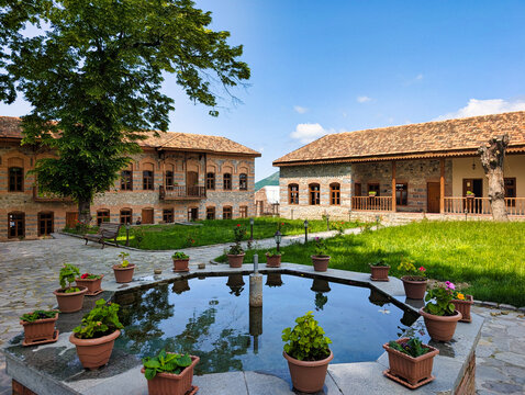 View of the historic courtyard with an octagonal fountain and traditional stone architecture at the Palace of Shaki Khans in Sheki, Shaki District, Azerbaijan.