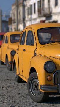 Yellow vintage taxi cars parked on a city street