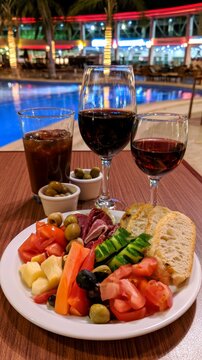 Wine and appetizers enjoying evening by resort pool