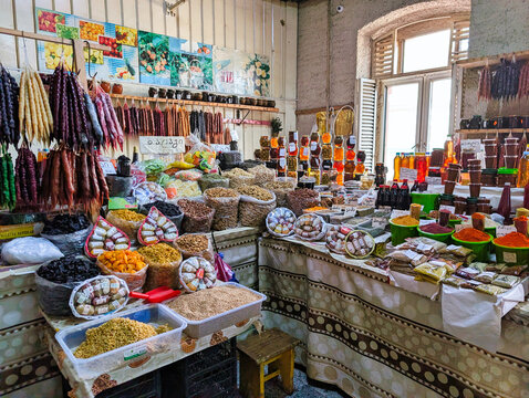 View of a traditional market stall filled with colorful churchkhela, assorted spices, dried fruits, and nuts in Tbilisi, Tbilisi, Georgia.
