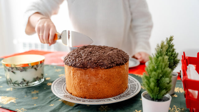 Cutting Panettone Cake for New Year Breakfast at Home