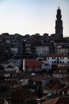 View of Torre dos Clerigos rising above the historic rooftops and dense urban architecture of Porto, Porto, Portugal.