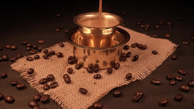 A traditional south indian filter coffee over beans background