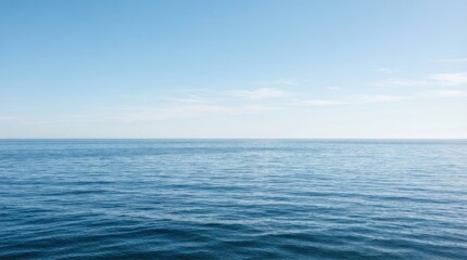 Fototapeta premium Vast blue ocean horizon with gentle waves under a clear sky
