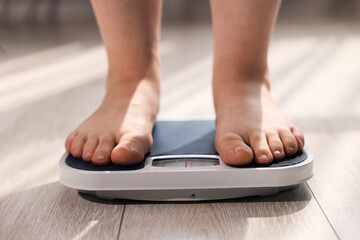 Fototapeta premium Overweight woman on scale at home, closeup