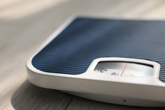 Mechanical scale on floor indoors, closeup view