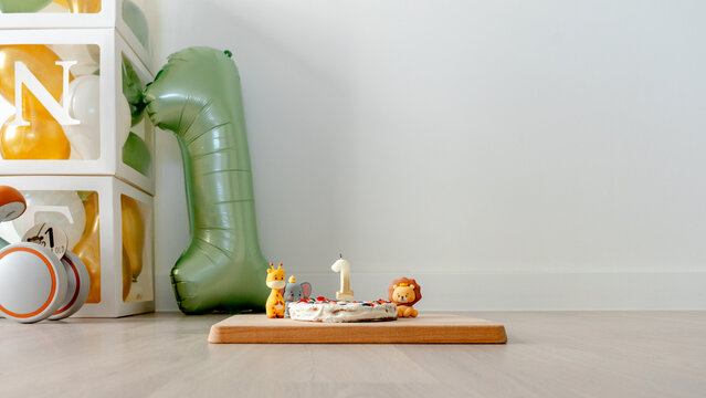 First birthday cake with animal figures and candle