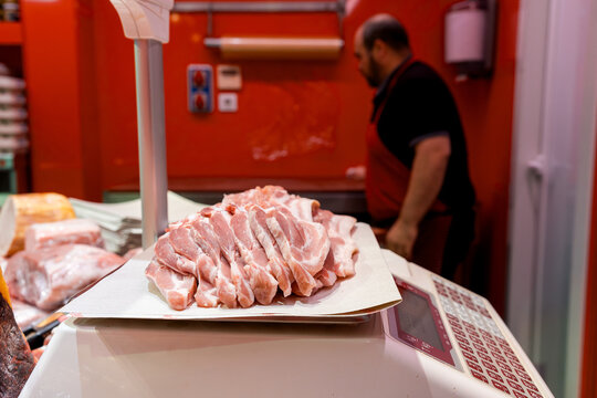 Fresh sliced meat on scale at butcher shop counter