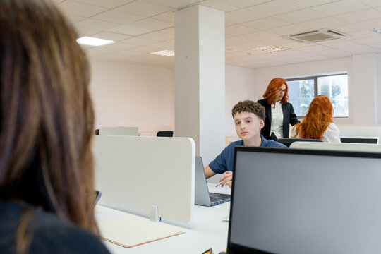 MBA students collaborate in a modern computer classroom