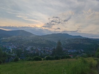 Fototapeta premium Scenic view of green Carpathian mountains hills covered with forest under cloudy sky