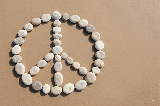 pebble peace symbol on sandy beach creating message of harmony and tranquility