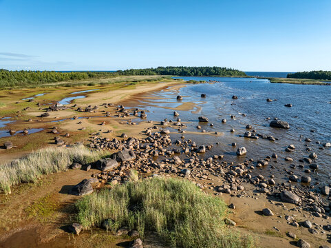 Beautiful summer landscape of Lake Ladoga coast showing effects of drought and low water levels on the stony shoreline