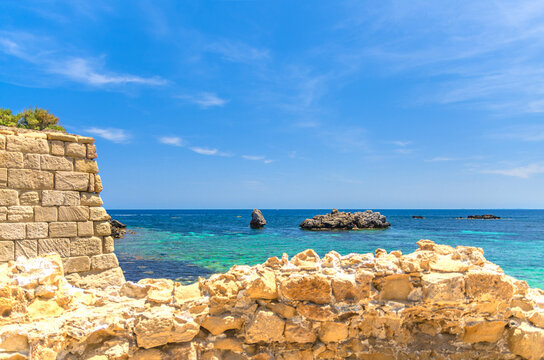 Stone wall on Tabarca Island Nueva Tabarca Isla Plana, Rock island in azure water Cova del Llop Mari Mediterranean Sea Alicante bay in sunny summer day, Alicante province, Valencian Community, Spain