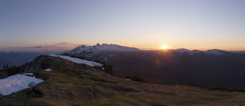 View of sunrise over the Stoderzinken mountain range with snow-capped peaks and alpine meadows in Grobming, Steiermark, Austria.