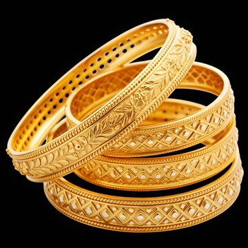 Luxury stack of traditional Indian gold bangles with intricate carved patterns and sparkling design on black background
