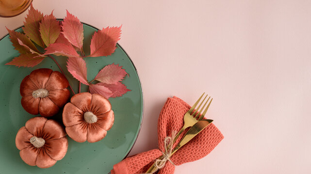 Autumnal Table Setting with Velvet Pumpkins Decorative Leaves and Gold Cutlery