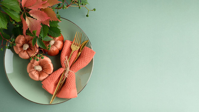 Autumn Table Setting With Velvet Pumpkins Napkin Cutlery And Greenery