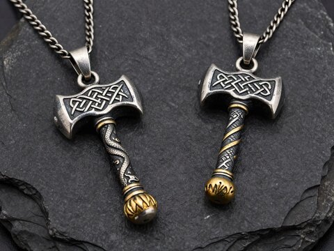 Two Thor hammer pendants on chains
