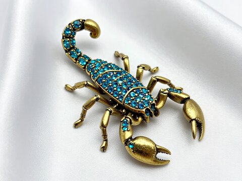 Gold scorpion brooch turquoise stones
