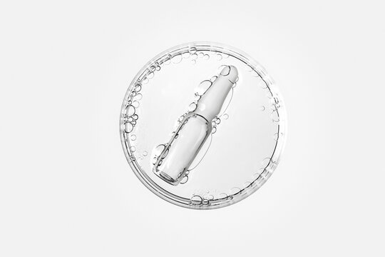 Transparent glass ampoule in petri dish with bubbles