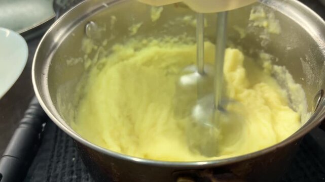 Creamy mashed potatoes being prepared in a bowl, homemade comfort food, cooking process and everyday kitchen meal.