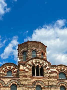 Detail of the medieval Byzantine dome and brick arches of the Church of Christ Pantocrator under a blue sky in Old Nessebar, Bulgaria