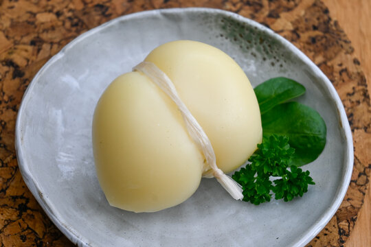 Italian cheeses white scamorza cow milk cheese from Puglia, Italy