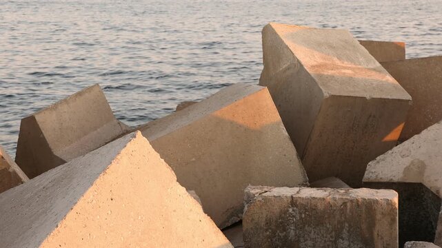 Unique cubist concrete blocks, New Harbor, Hermanus, South Africa at sunset. 