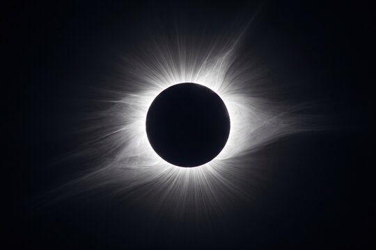 Total solar eclipse showing the sun's corona against a dark background