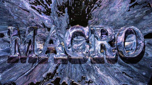 Metallic liquid letters exploding from iridescent purple and blue splash in dramatic closeup