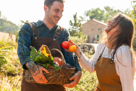 Joyful farmers harvesting fresh produce.