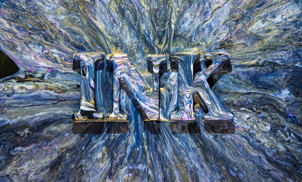 Metal letters N and K covered in iridescent oil slick with flowing marbled background