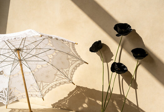 Lace parasol, vintage lace umbrella, black poppy flowers, floral arrangement, natural shadow, aesthetic wall decor, minimal arrangement, summer vibe.