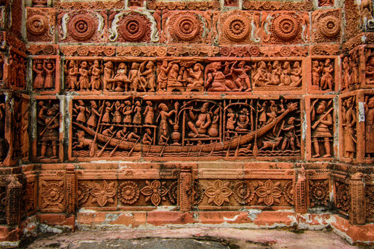 View of intricate terracotta relief carvings depicting traditional scenes and figures on the walls of the historic Kantajew Temple in Dinajpur District, Rangpur Division, Bangladesh.